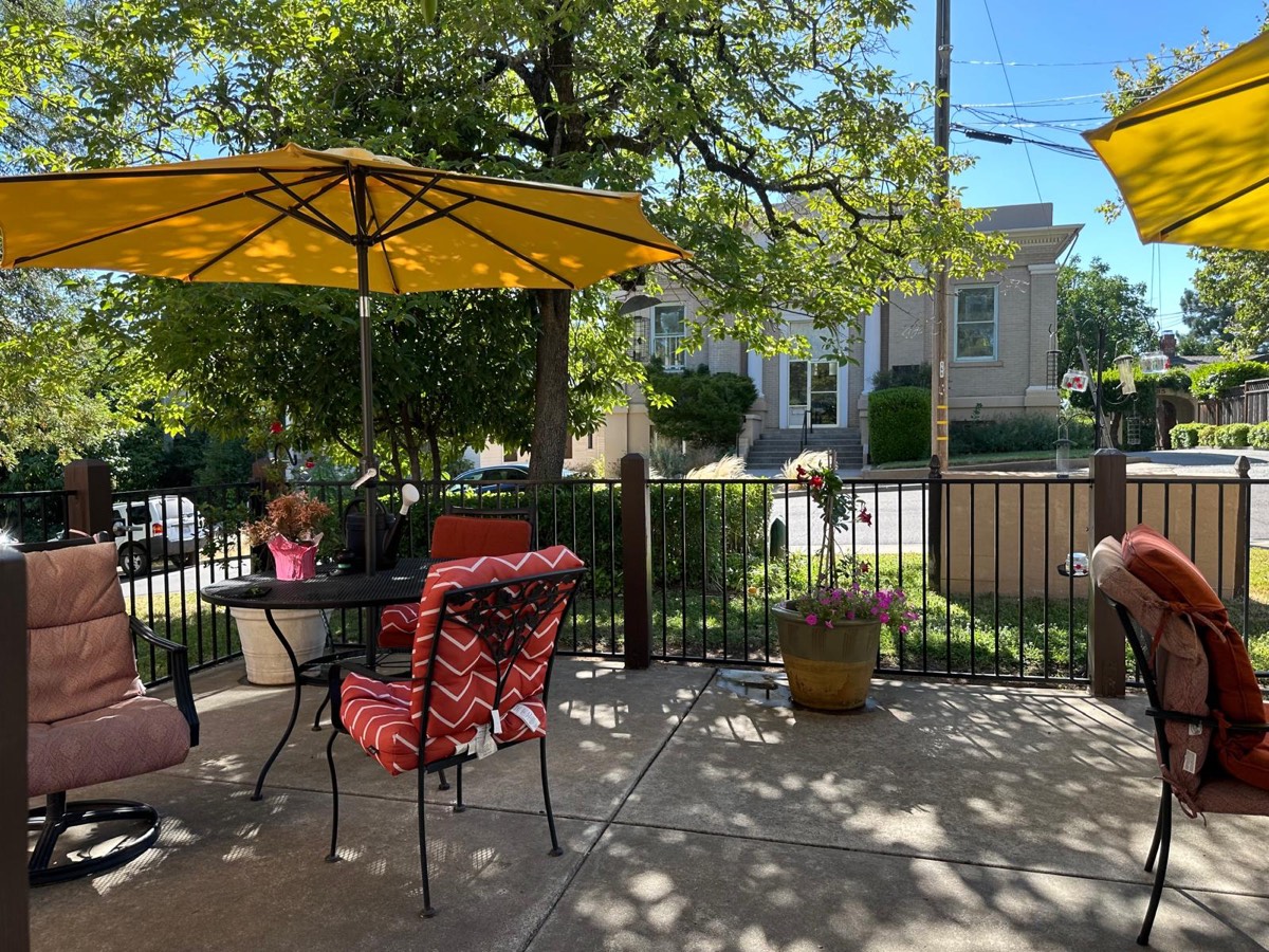 The patio, with shaded seating looking onto the street
