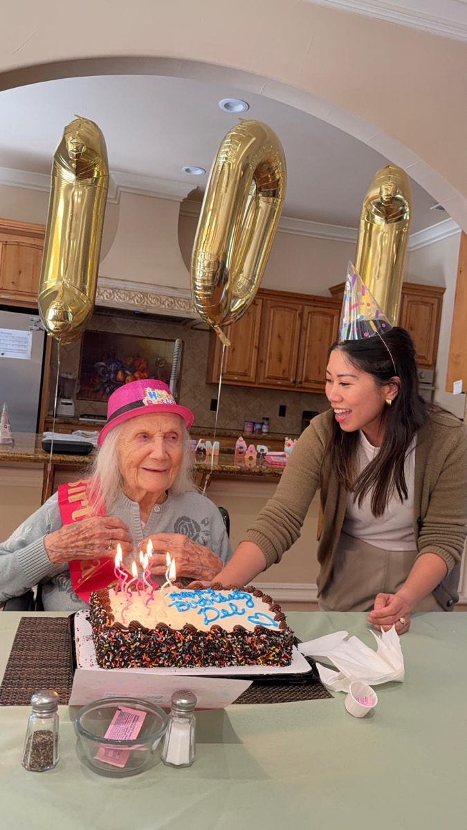 A birthday cake being presented to a resident